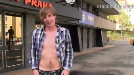 Young euro boy is performing public striptease for money